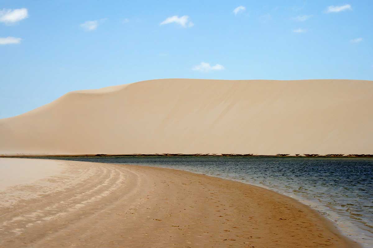 Composed of large, white, sweeping dunes, at first glance Lençóis Maranhenses looks like an archetypal desert, but in fact it is not an actual desert. Lying just outside the Amazon Basin, the region is subject to a regular rain season during the beginning of the year.