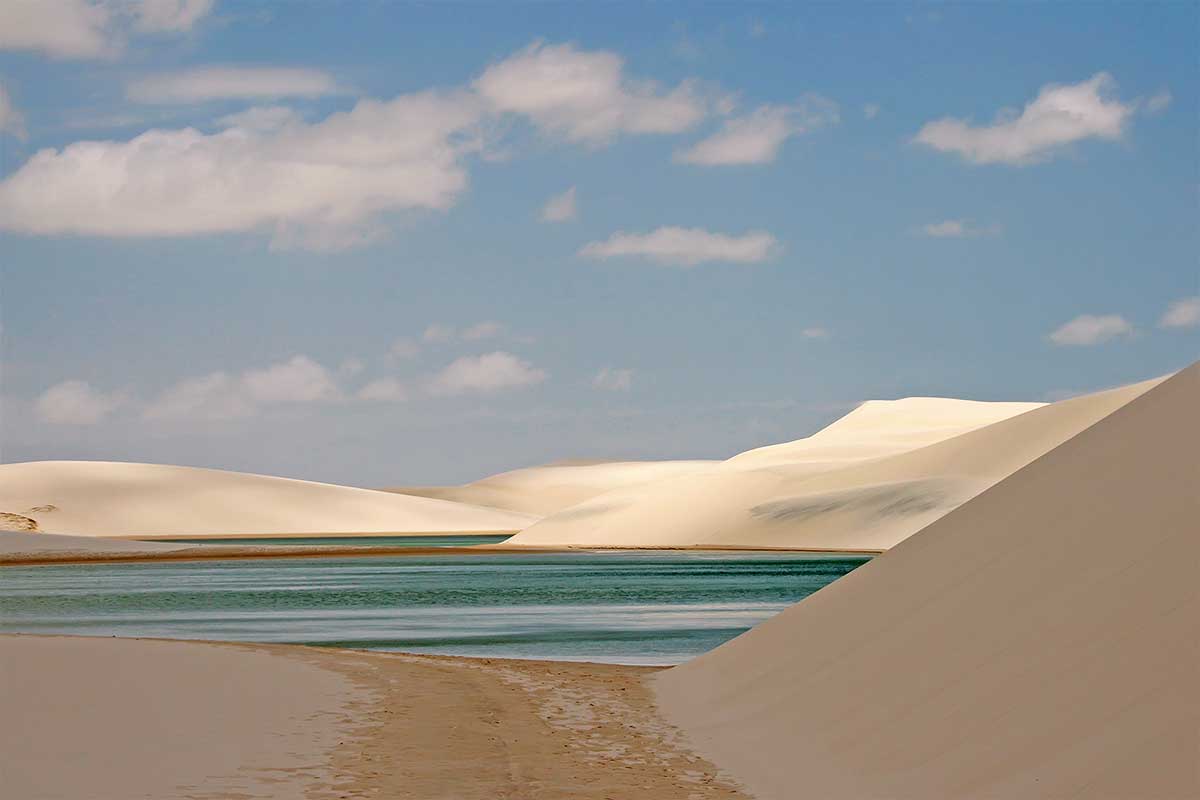 Lençóis Maranhenses National Park is an area of low, flat, occasionally flooded land, overlaid with large, discrete sand dunes. It encompasses roughly 1.500 km2, and despite abundant rain, supports almost no vegetation.