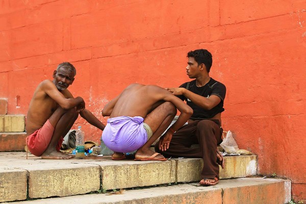 man-shaving-hair-ghats-varanasi-india Man shaving his hair on the Ghats before taking a "holy dip" in the Ganges.