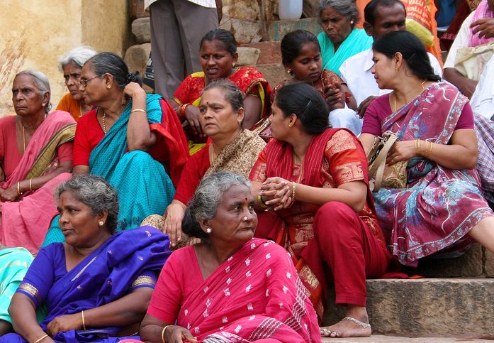 red-women-india Women sitting on the Ghats in Varanasi.