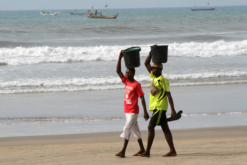 ghana-takoradi-beach-men-walking Two men on their way home.