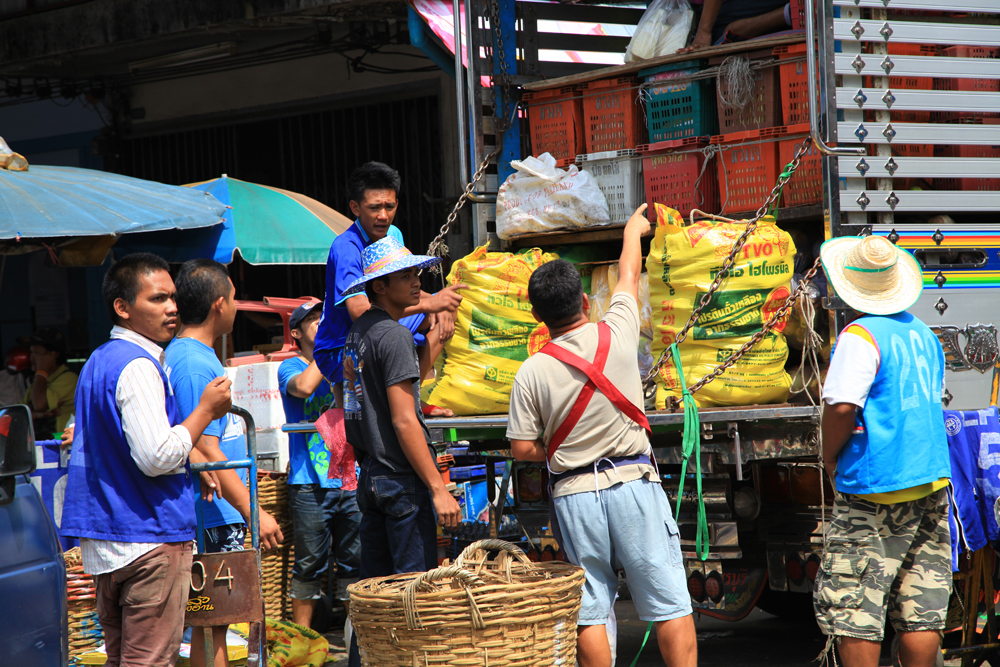 Porters roam the streets of Khlong Toey fresh market, waiting for customers to uploading their latest purchases.