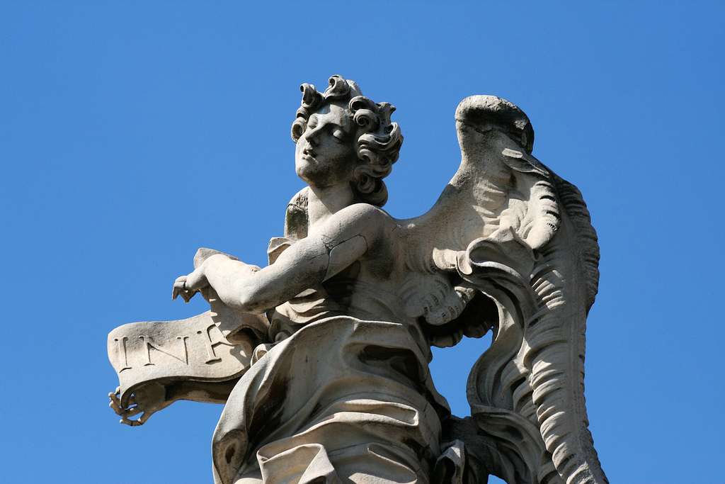 An angel in front of Castel Sant'Angelo in Rome. It was initially commissioned by the Roman Emperor Hadrian as a mausoleum for himself and his family. The building was later used by the popes as a fortress and castle, and is now a museum.