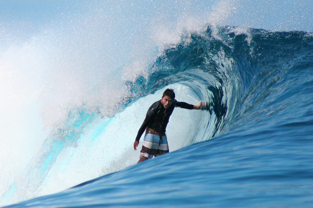 Dennis Tihara surfing at Teahupoo, Tahiti.