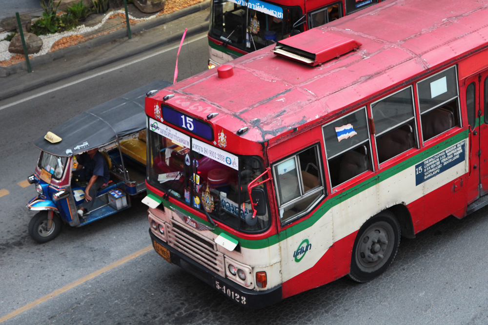 tuk-tuk-or-bus-bangkok-thailand Buses in Bangkok provide an incredibly cheap way to travel from one side of the city to another. It's also a great way to see the real Bangkok you don't often see if you're traveling by other means of transportation.