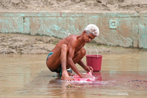 man-washing-his-cloth-ganges-river-varanasi-india A man washing his cloth in the Ganges river.