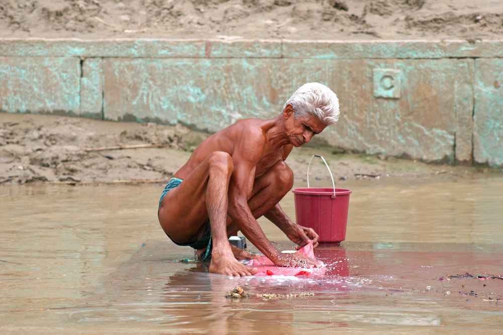 man-washing-his-cloth-ganges-river-varanasi-india People use the Ganges river for bathing, laundry, washing, eating, cleaning utensils, and brushing teeth.