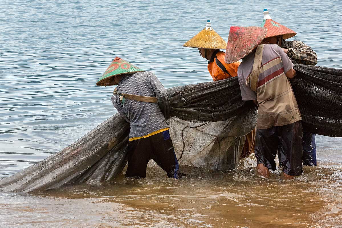 Fishermen pulling in a catch at Bungus beach in Sumatra.