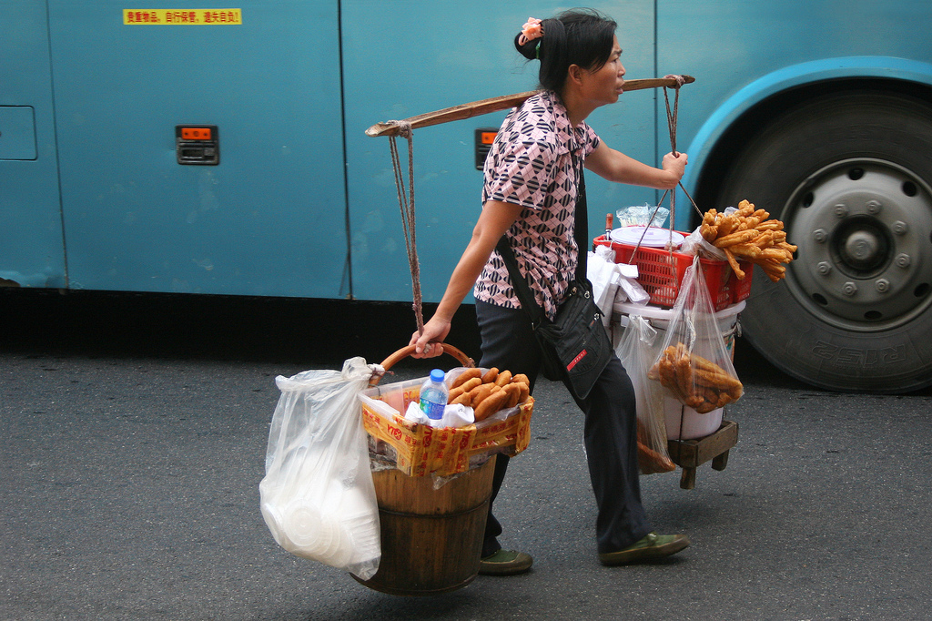 Woman selling small snacks at the Guangzhou railway station.