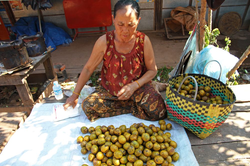 Selling goods at a market in Vientiane.
