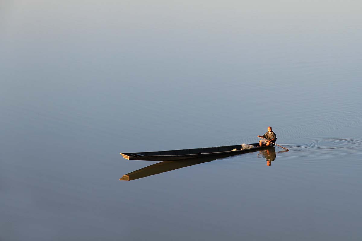 mekong-river-man-boat-vientiane-laos As slow as the Mekong river runs through Vientiane, life along its banks is.
