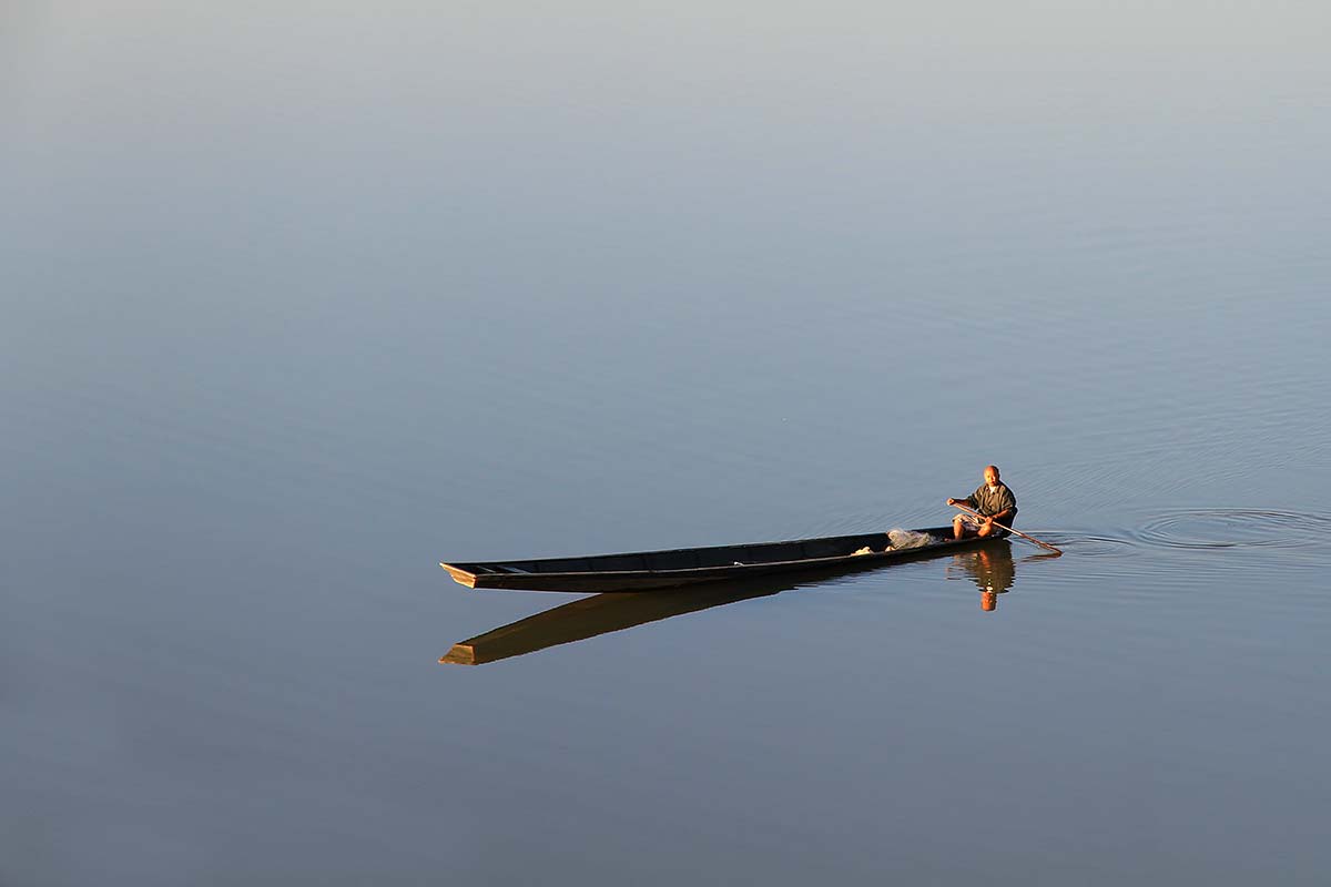 As slow as the Mekong river runs through Vientiane, life along its banks is.