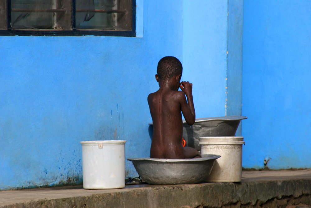 Blue - Boy and the blue wall in Accra, Ghana.