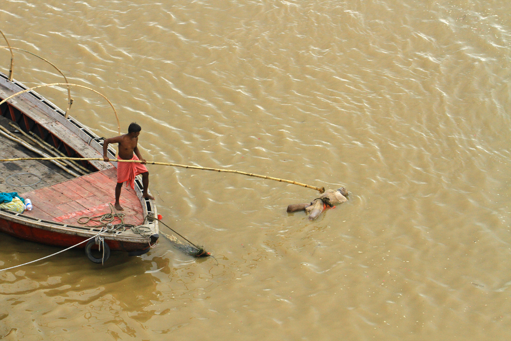 Dead body floating by in Varanasi, India.