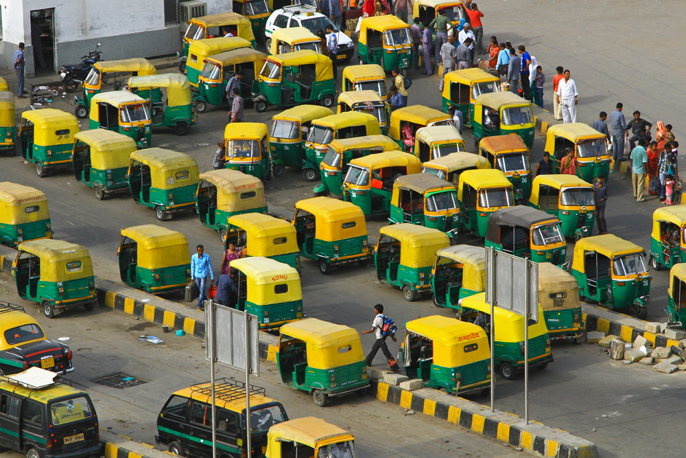 Tuk Tuks waiting for customers at the train station in New Delhi, India.