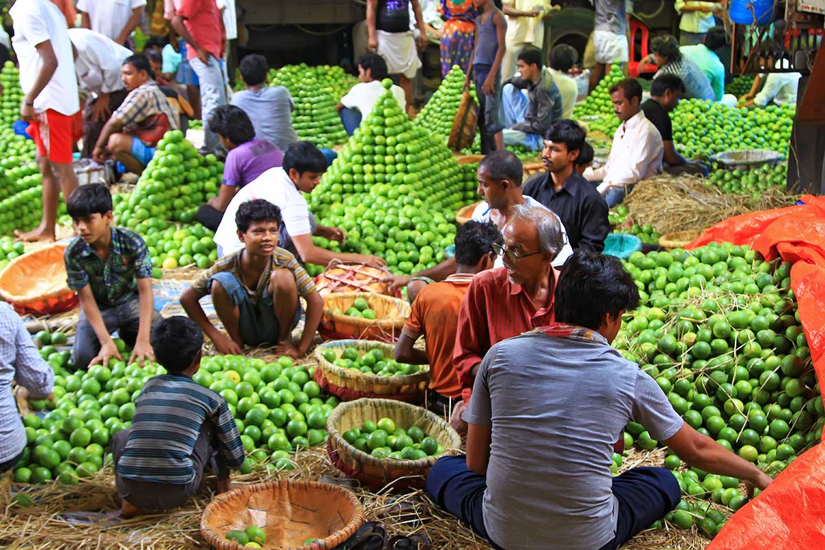 Working men at the orange section of the wholesale market in Kolkata.