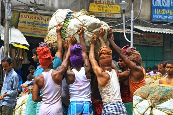 kolkata-india-hard-working-men-vegetable-market Pure manpower at the wholesale fruit market in Kolkata, India.
