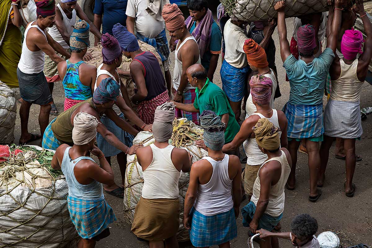 A typical market scene at the wholesale fruit market near the Howrah bridge in Kolkata.