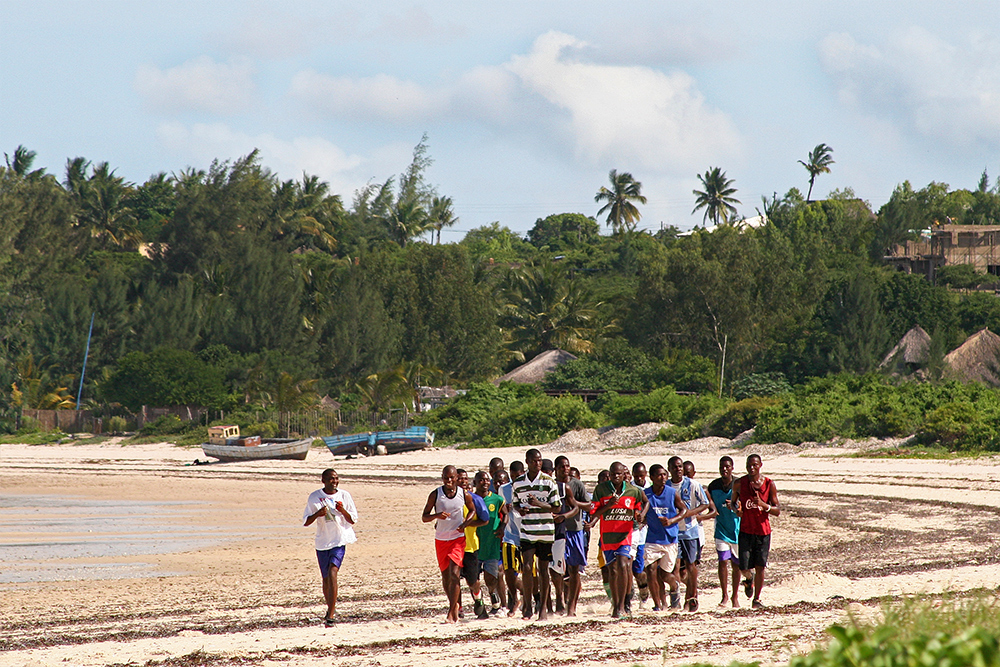 Men running on the beach near Bazaruto Island in Mozambique.