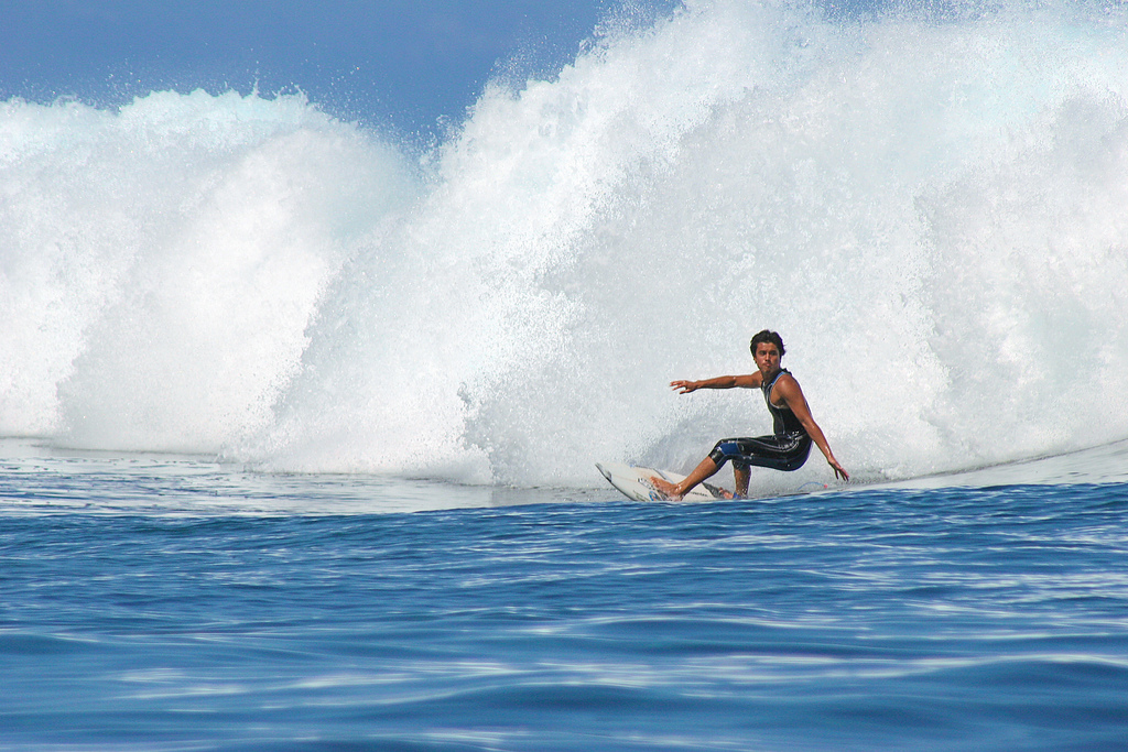 A surfer conquering the waves at Teahupoo, Tahiti.