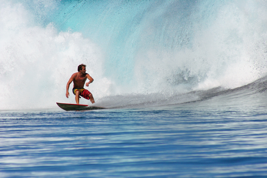 A surfer conquering the waves at Teahupoo, Tahiti.