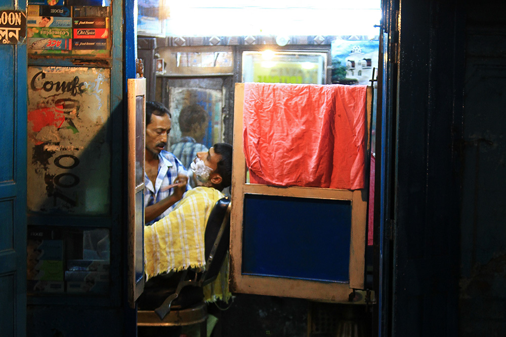 A barber shop in Varanasi at night.