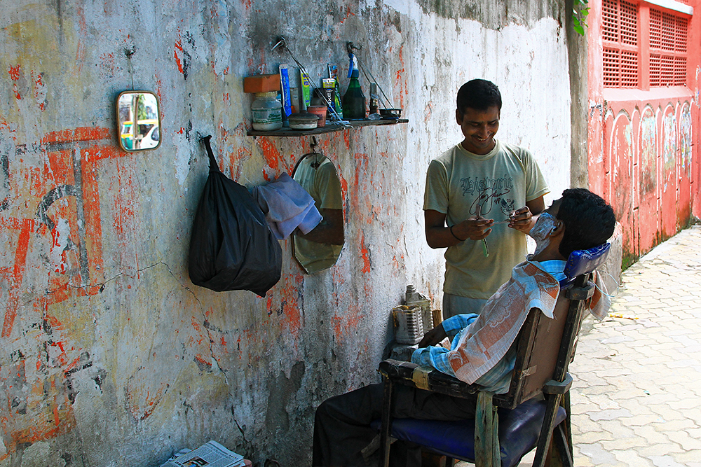 A typical barber in the side streets of India.