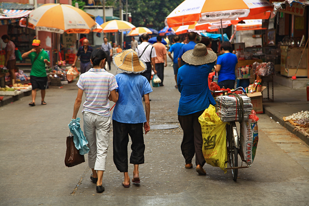 Walking along a side street in the old quarter of Guangzhou, China.