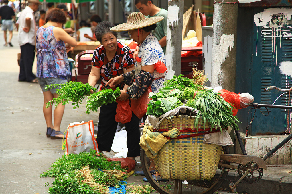 Women selling goods at a market in Guangzhou, China.