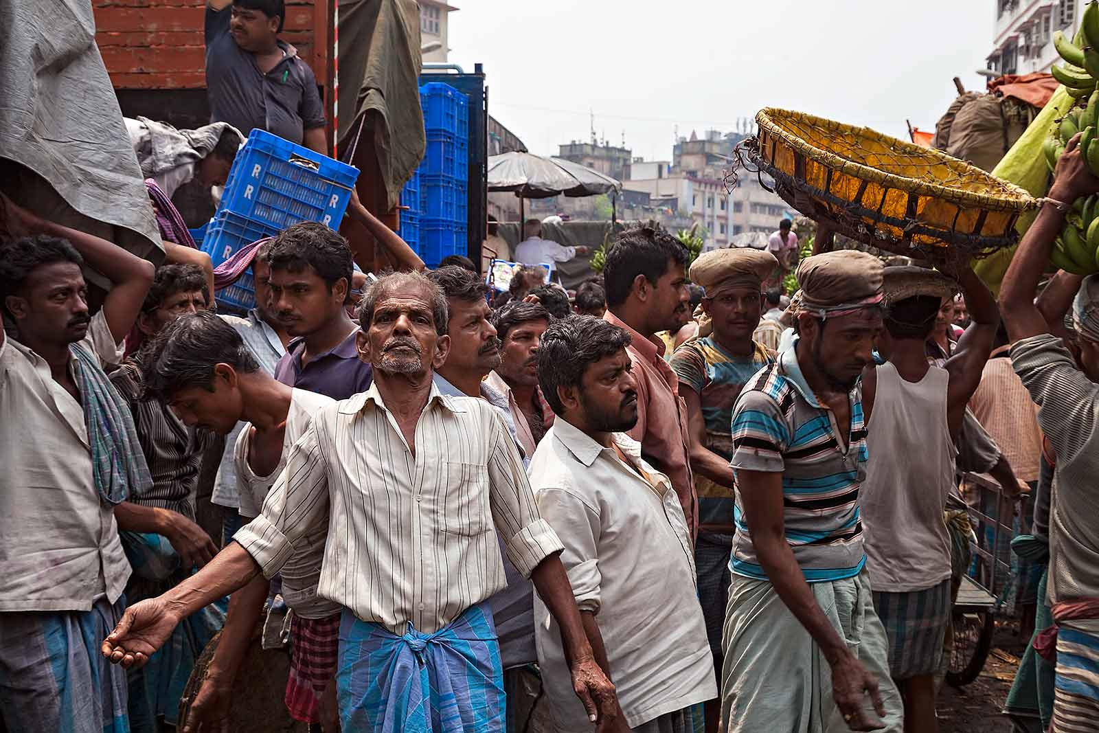 Working men at the the fruit wholesale market in Kolkata, India.