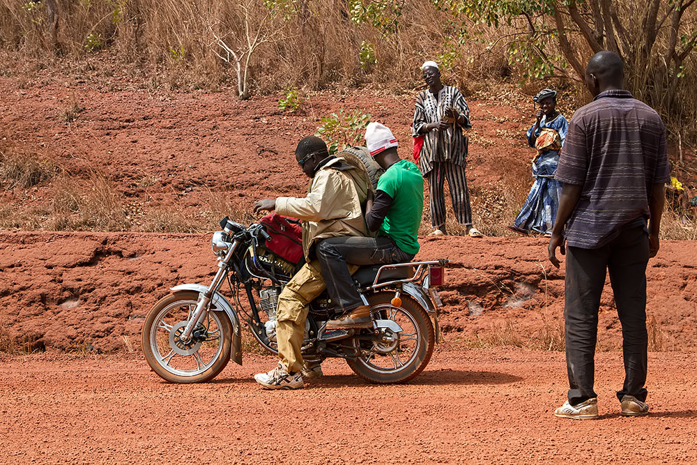 Ready to get a new tire for the broken down bush taxi in Burkina Faso.