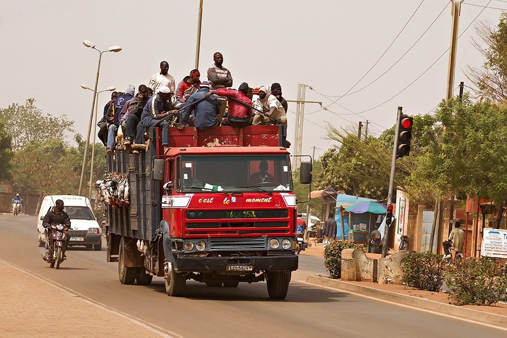 Africa Burkina Faso View Of Overloaded African Taxi With People Sitting On  Roof High-Res Stock Photo - Getty Images