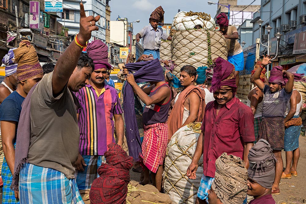 Hard working men at Kolay Market in Kolkata, India.