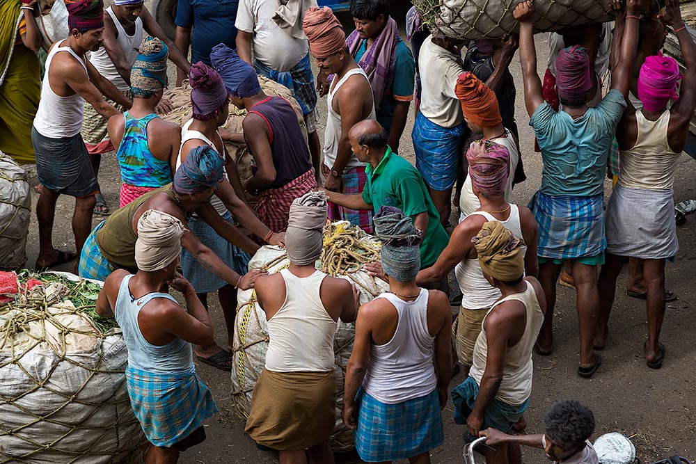 Hard working men at Kolay Market in Kolkata, India.