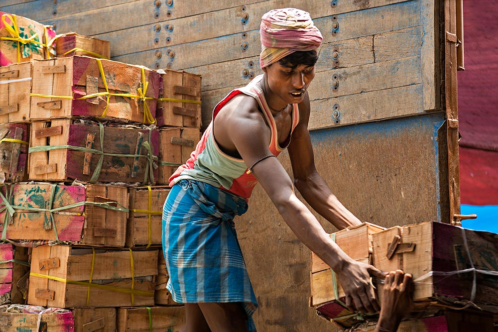 Hard working men at Mechua Market in Kolkata, India.