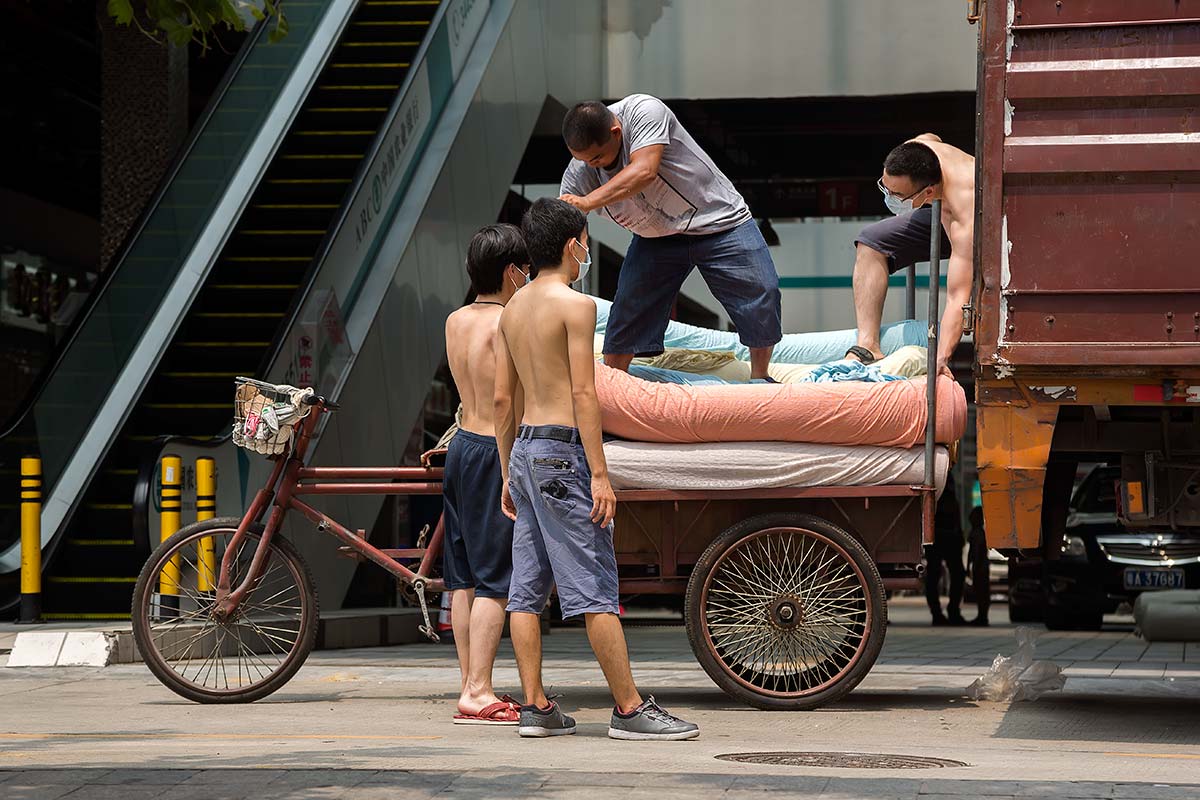 Chinese men unloading a truck in Beijing.