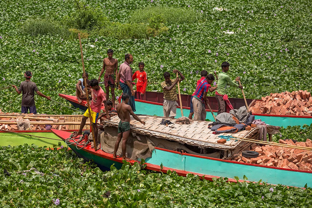 Transporting bricks along the Buriganga river and through Sadarghat port in Dhaka.