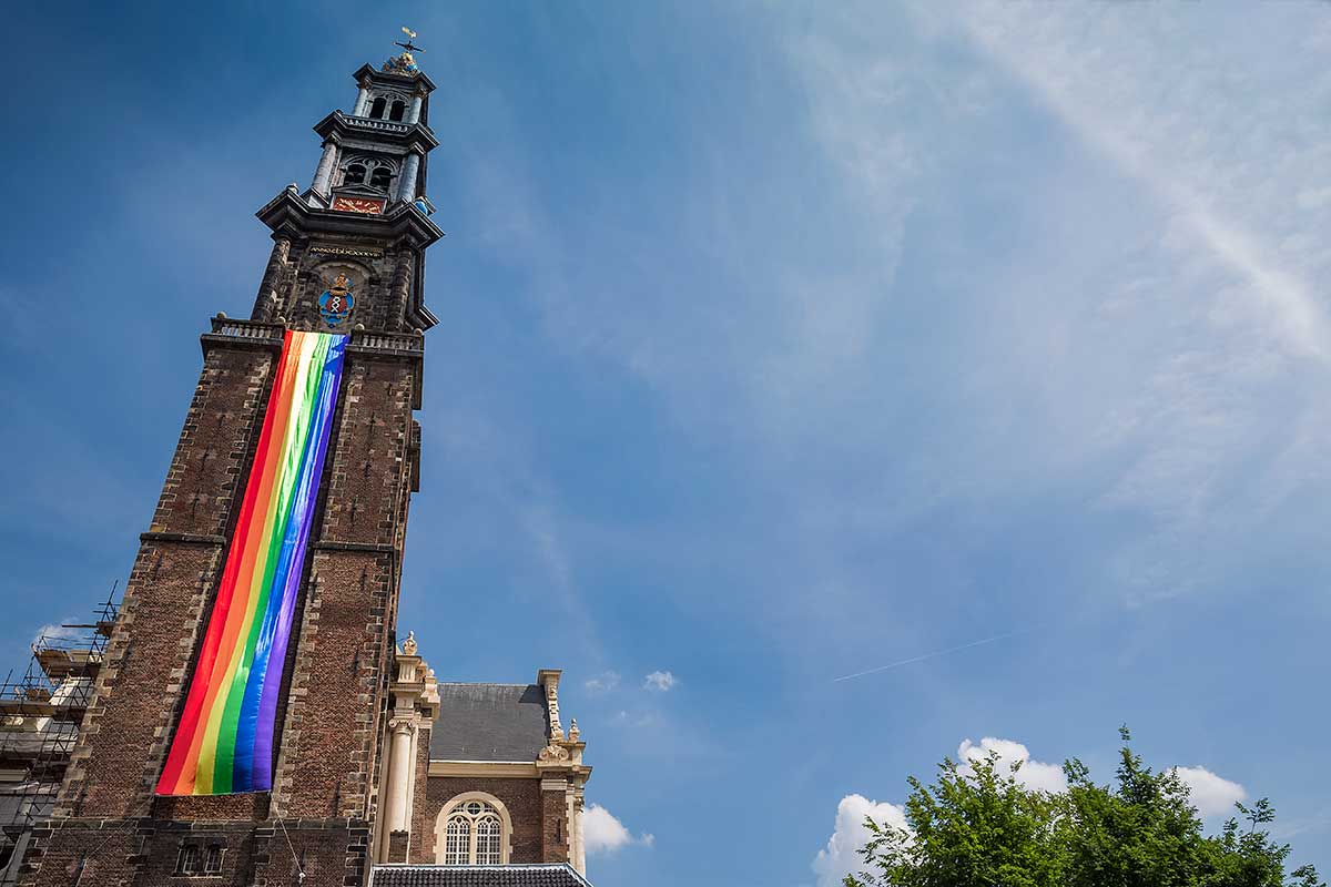 Westerkerk Church was covered in a rainbow flag. Something you unfortunately don't see very often, but in Amsterdam, EVERYONE goes along. | Amsterdam Canal Pride Parade 2014.