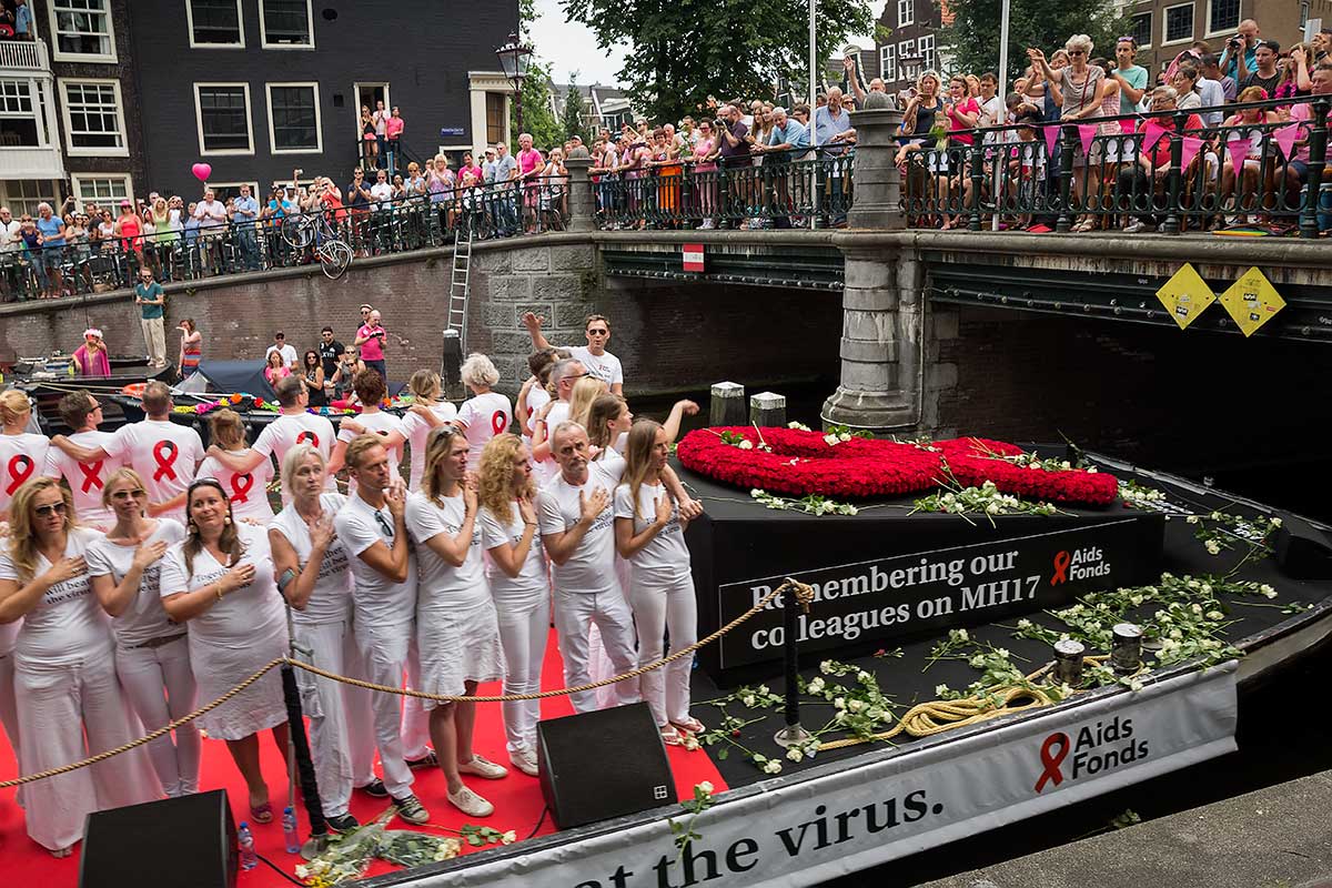 Members of the Aids Fonds organisation pay tribute to the victims of Malaysia Airlines flight MH17 at the start of the Amsterdam Canal Parade.