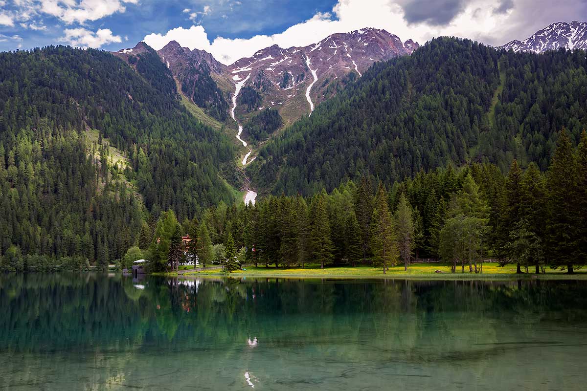 Reflections at the Antholzer See in South Tyrol, Italy.