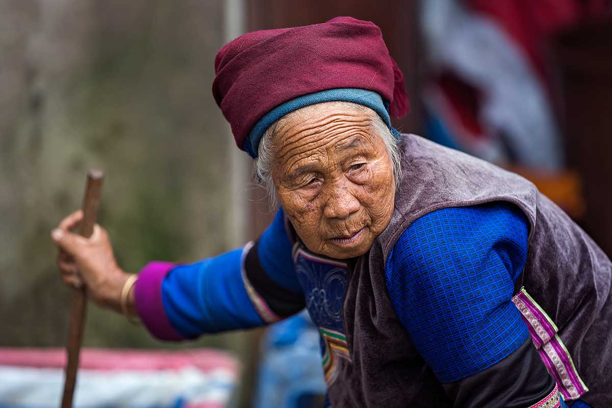 An old woman of the Hani minority at the market in Xinjie, Yunnan Province, China.