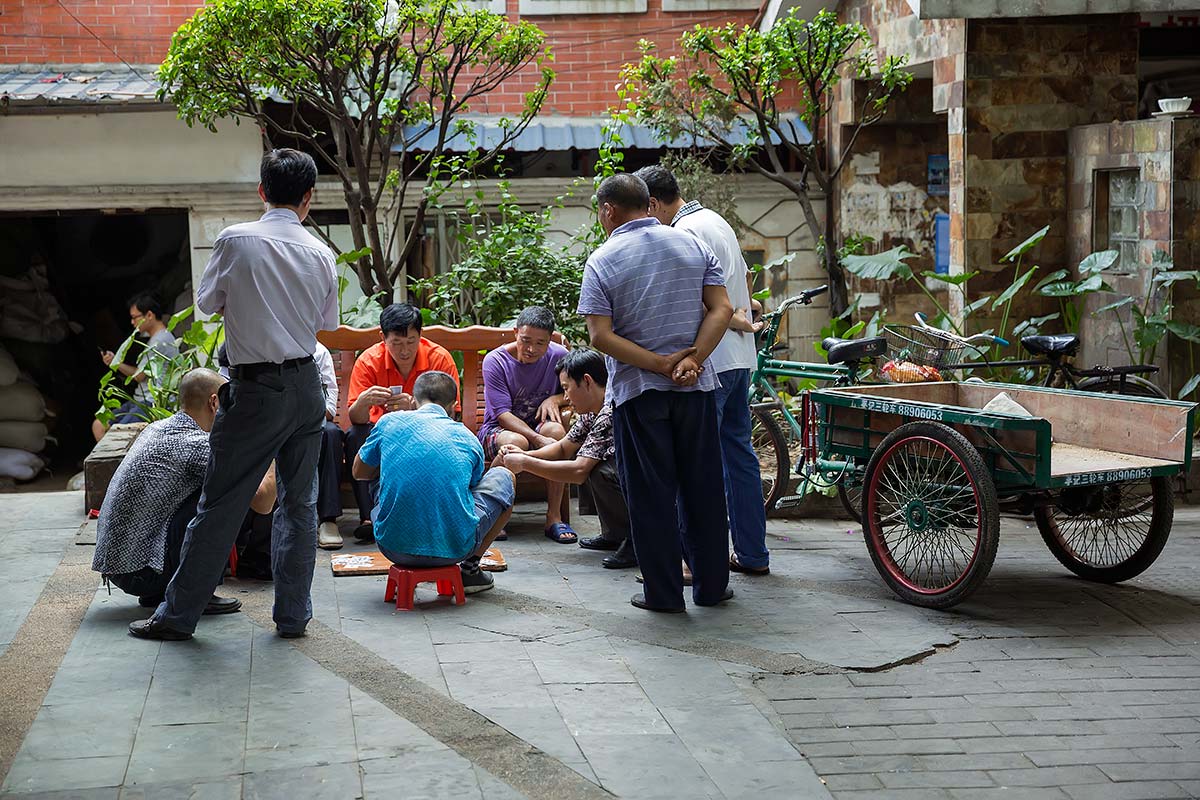 Chinese men playing a game of Mahjong in the streets of Guangzhou.