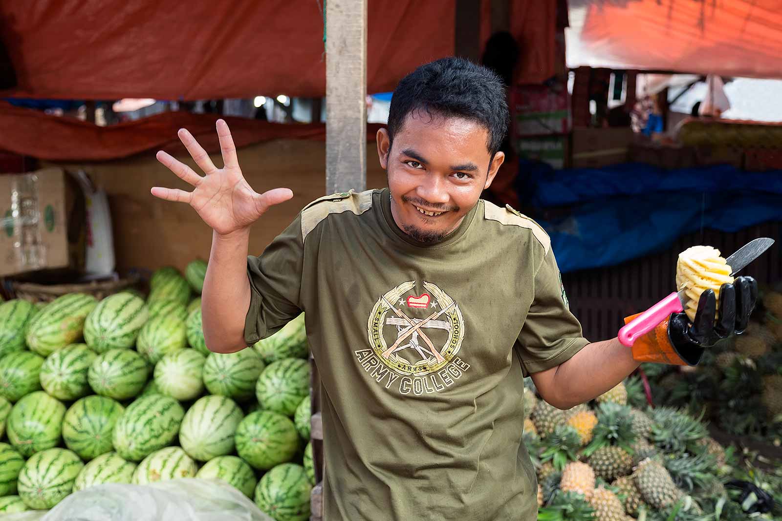 padang-market-man-selling-pineapples-sumatra-indonesia