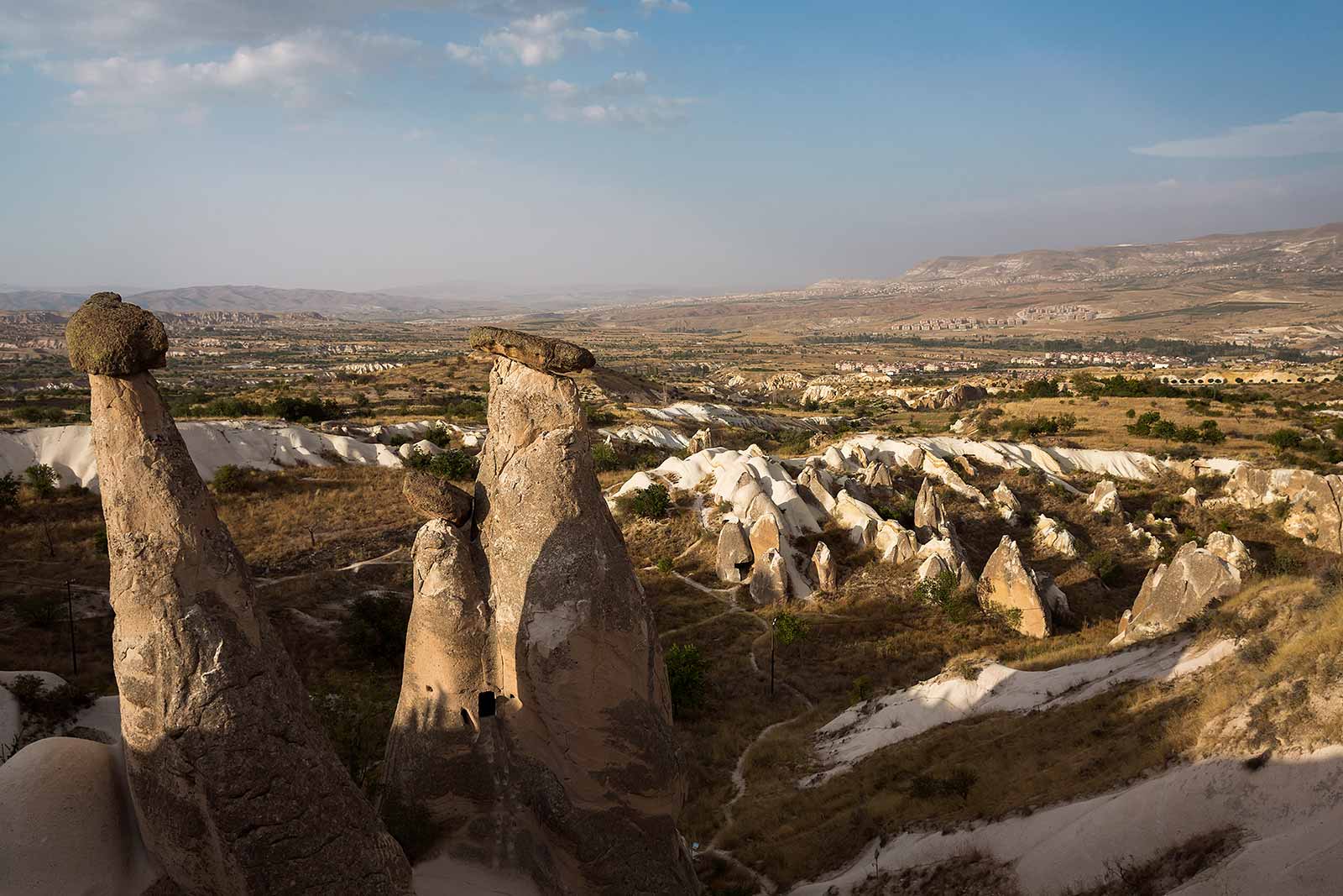 Volcanic eruptions created this surreal landscape of Cappadocia. The lava flows formed tuff rock, which wind and rain sculpted into sinuous valleys with curvy cliff faces and pointy fairy chimneys.