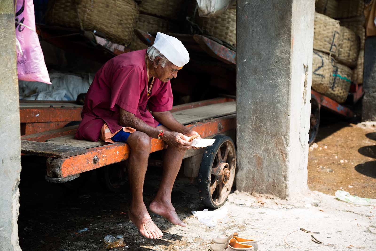 This wholesale trader at the Sassoon Docks counts his money after a busy morning.